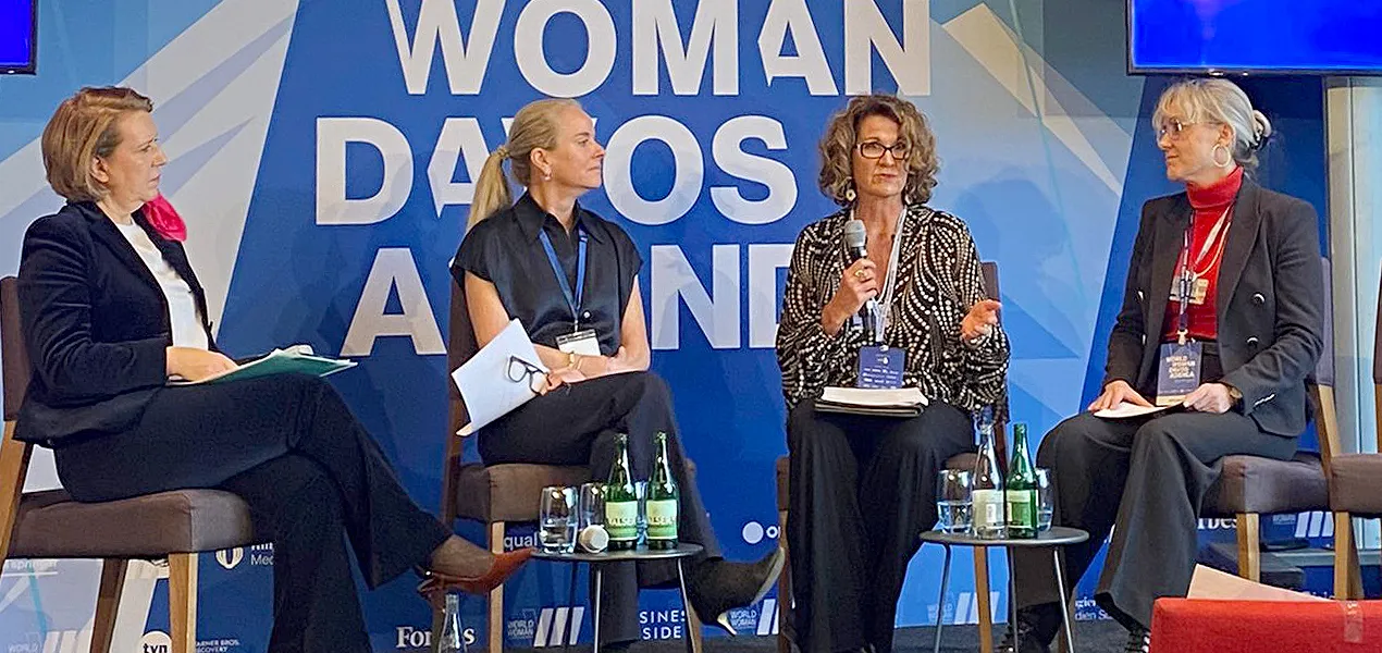 Four women sit on a stage for a panel discussion.