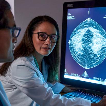 Providers reviewing x-ray on monitor in dark office setting